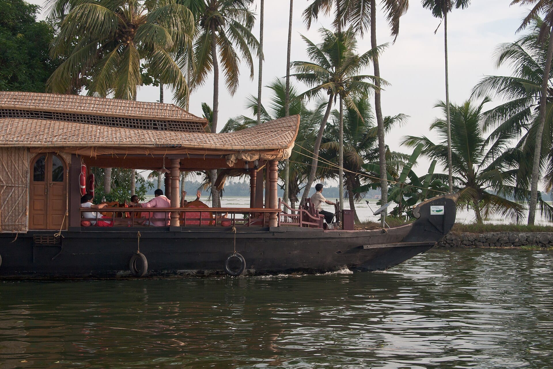 A traditional houseboat cruising the palm-lined Kerala backwaters